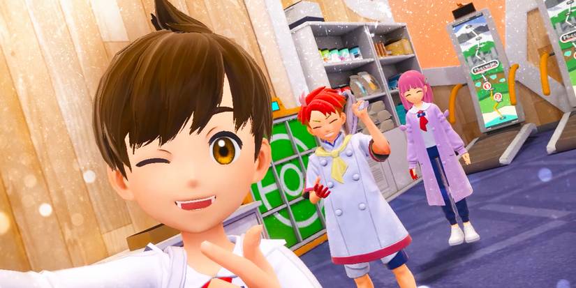 Three characters from Pokémon Scarlet and Violet's The Teal Mask DLC. One is holding the camera and taking a selfie, winking, with the other two smiling in the background.