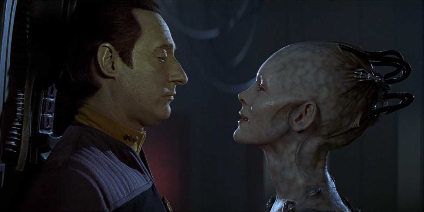 Data and the Borg Queen stare at each other while standing close together in Star Trek: First Contact.