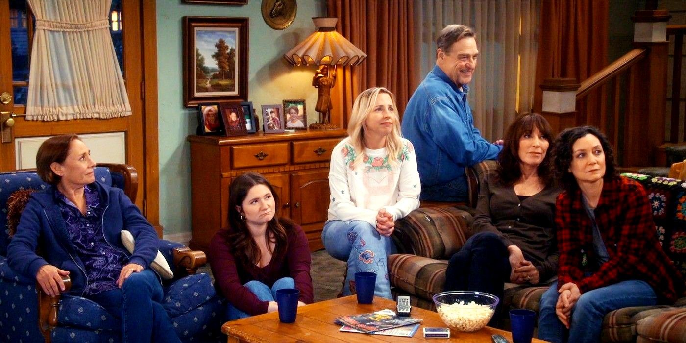 The Conner family sitting together in a cabin in The Conners