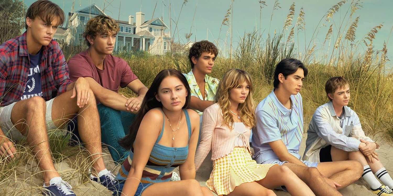 The Summer I Turned Pretty season 2 cast sits on the beach.