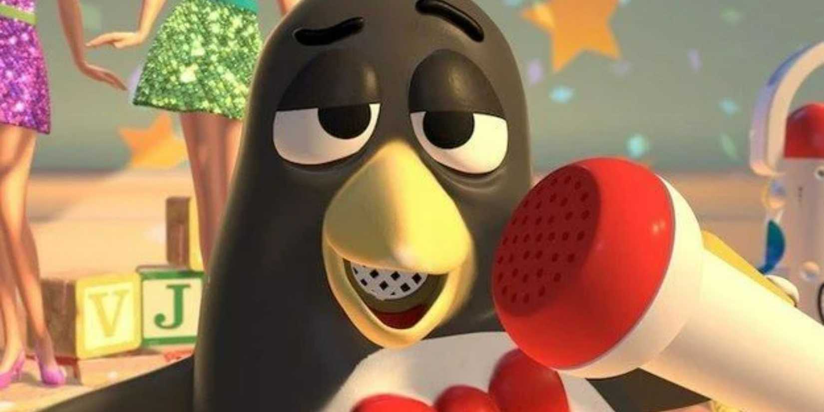 Toy Story 2's Wheezy singing into a microphone while Barbie toys stand behind him