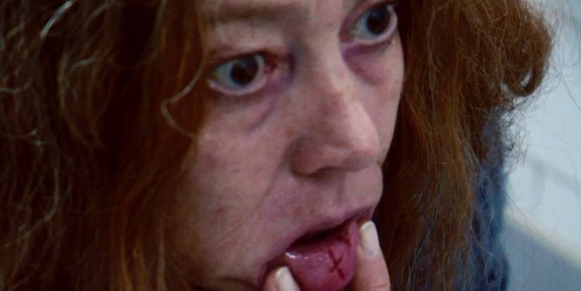 Woman Sticking Out Her Tongue with a Cross On It in The Devil Inside