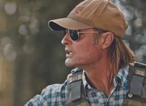 Roarke fishing while looking at something off-camera in Yellowstone.