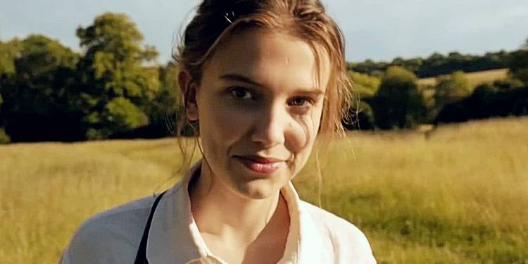 Millie Bobby Brown as Enola Holmes in a scene from Enola Holmes 2 looking offscreen