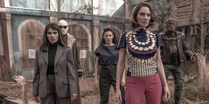 The Doom Patrol season 4 cast stands in front of an overgrown building