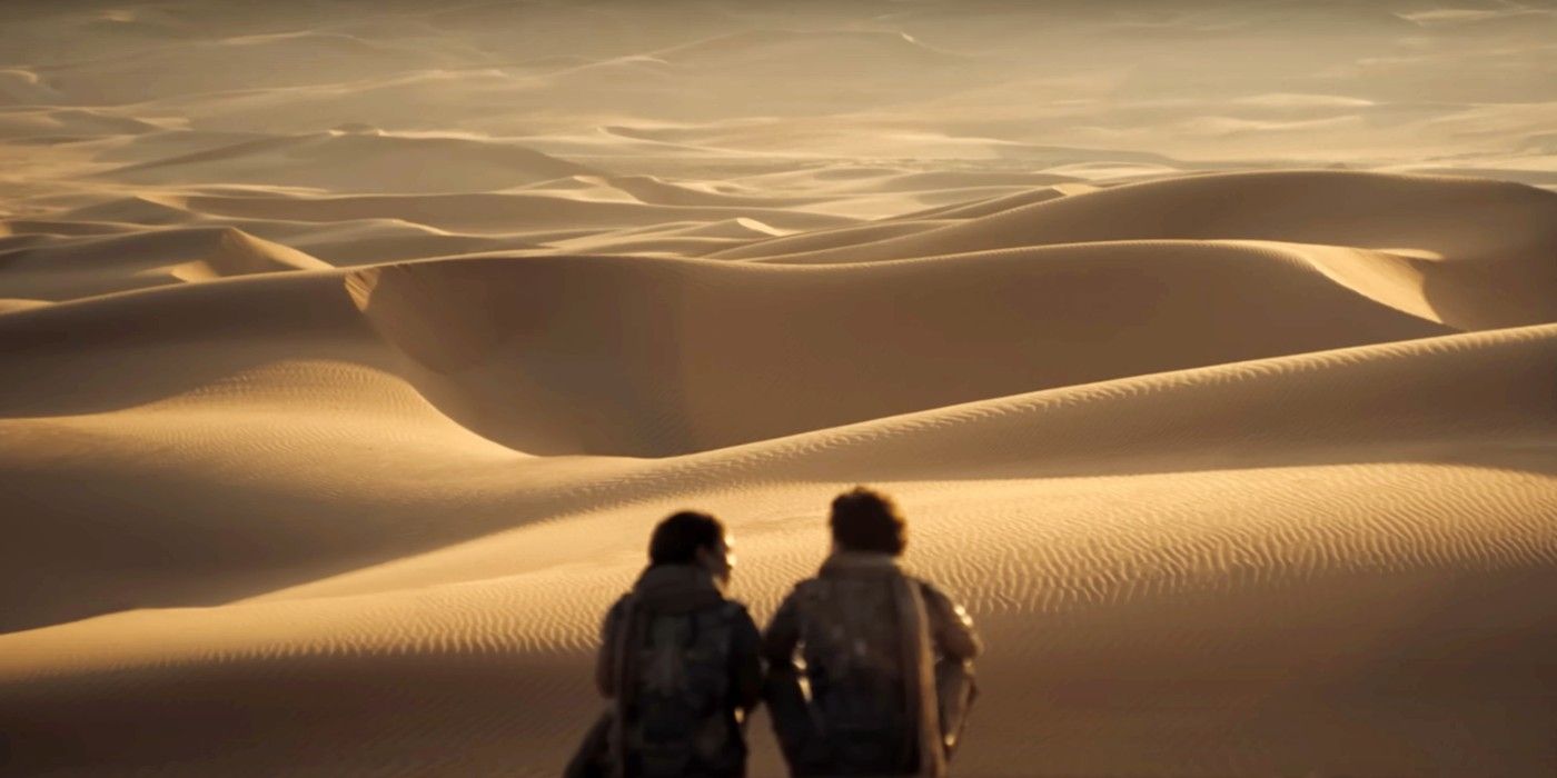 Timothee Chalamet as Paul and Zendaya as Chani sitting on a sand dune in Dune: Part Two.