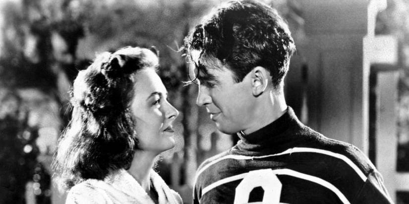 Donna Reed as Mary Hatch Bailey and James Stewart as George Bailey looking at one another in It's a Wonderful Life