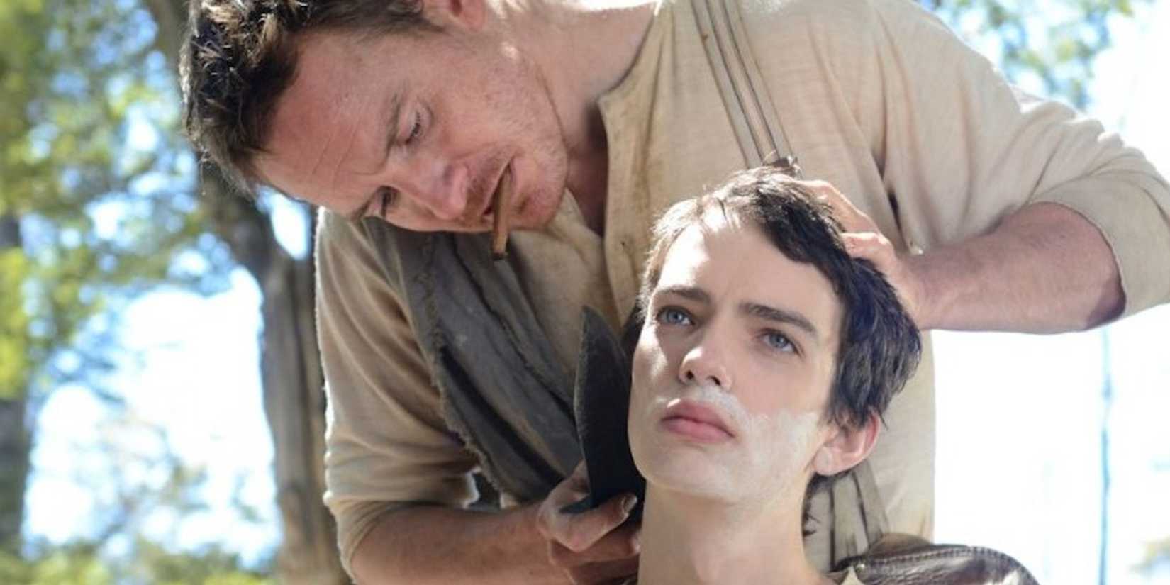 Michael Fᴀssbender shaves Kodi Smit-McPhee in Slow West