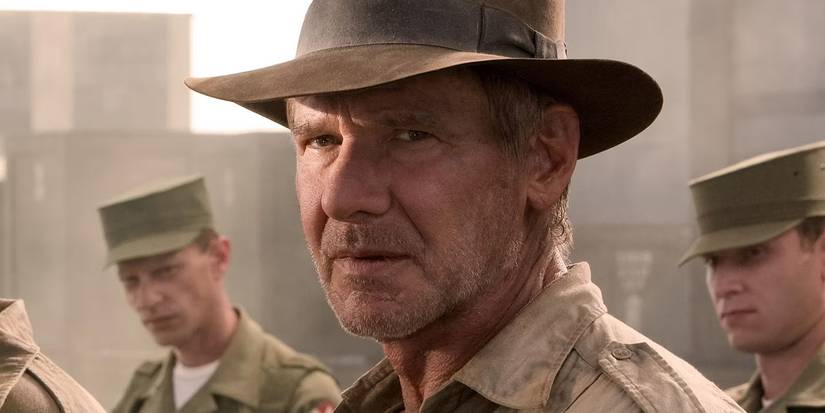 Harrison Ford as Indy staring off at something, with soldiers stood behind him, in Indiana Jones and the Kingdom of the Crystal Skull.