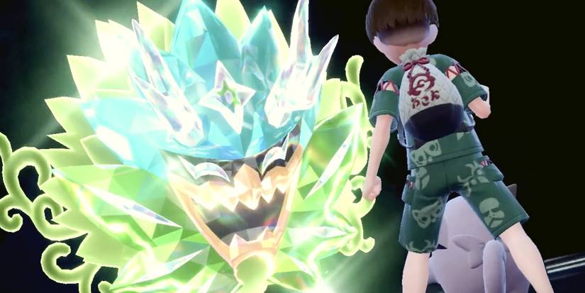 A Pokémon trainer with a Clefairy facing off against Ogerpon Terastallized with the Teal Mask.