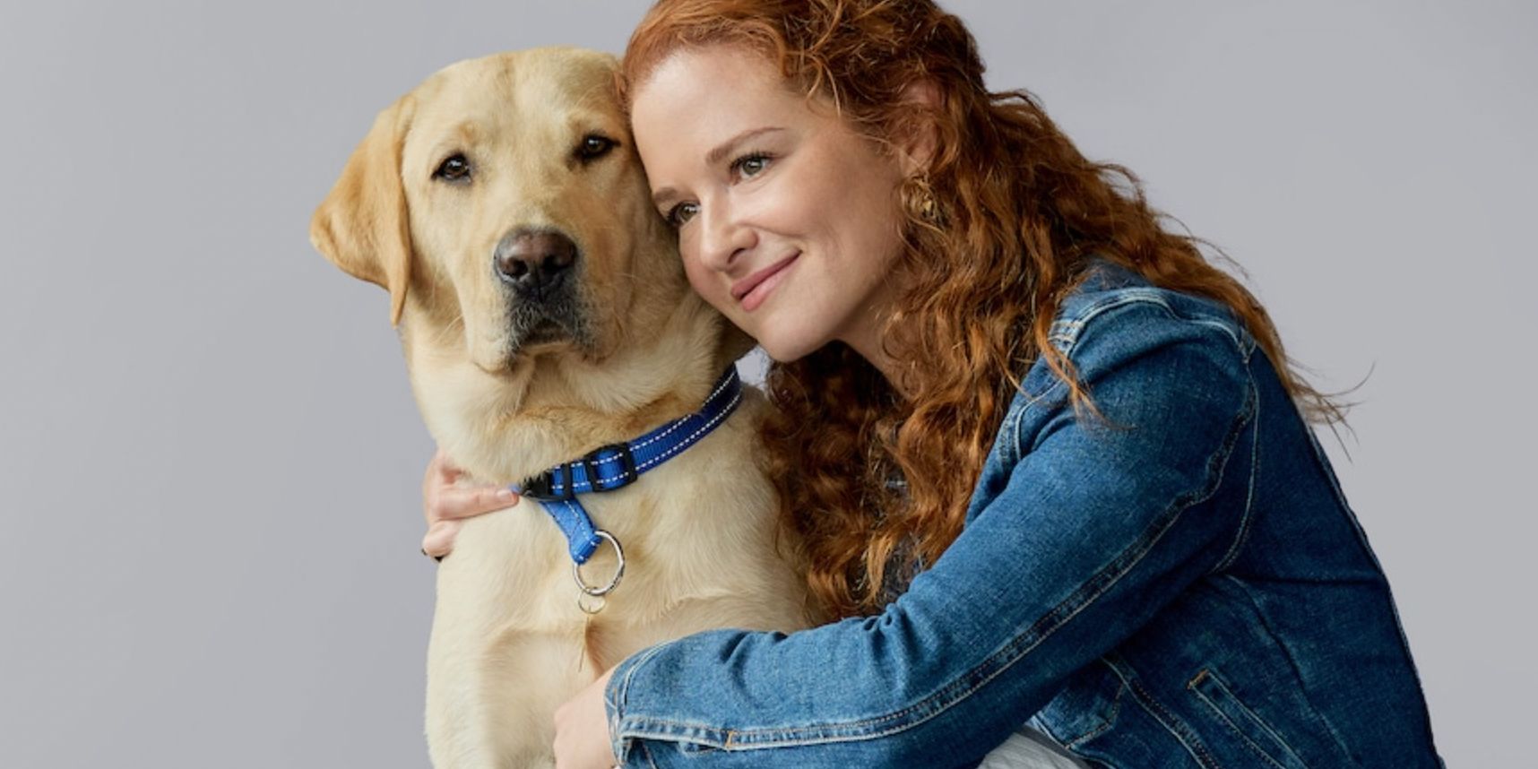 Sarah Drew hugging a dog for Guiding Emily