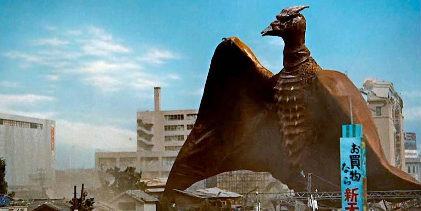 Rodan caminhando por uma área urbana