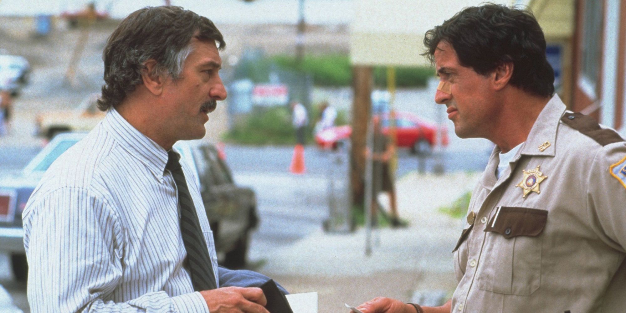 Sylvester Stallone talks to Robert De Niro in Cop Land