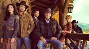 The cast of Yellowstone on a cabin porch