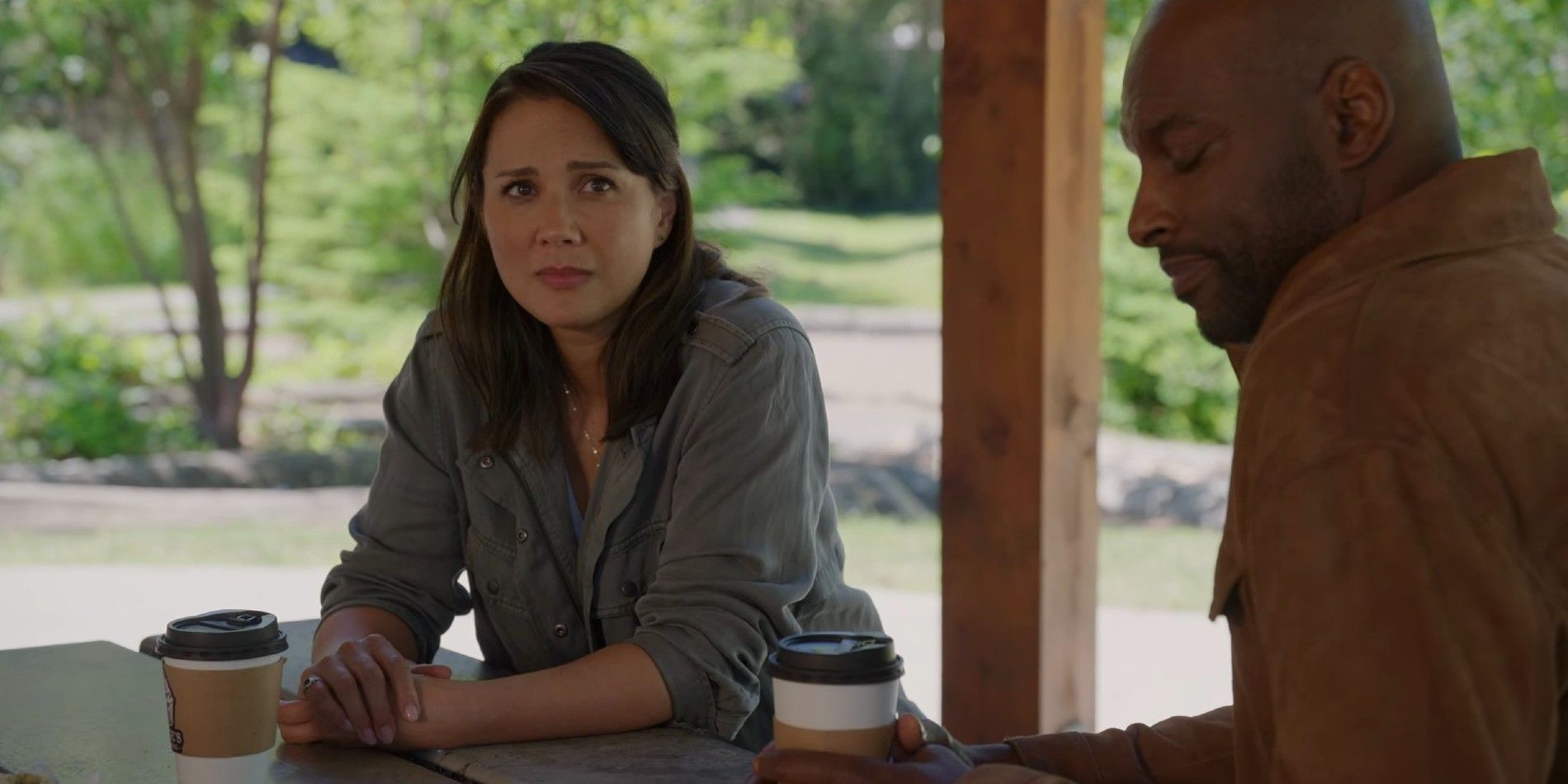 Preacher and Paige look upset while sitting and drinking coffee in Virgin River.