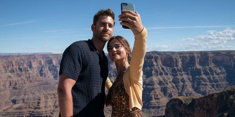 Oliver Jackson-Cohen as Will Taylor and Jenna Coleman as Liv Taylor taking a photo together in Wilderness.