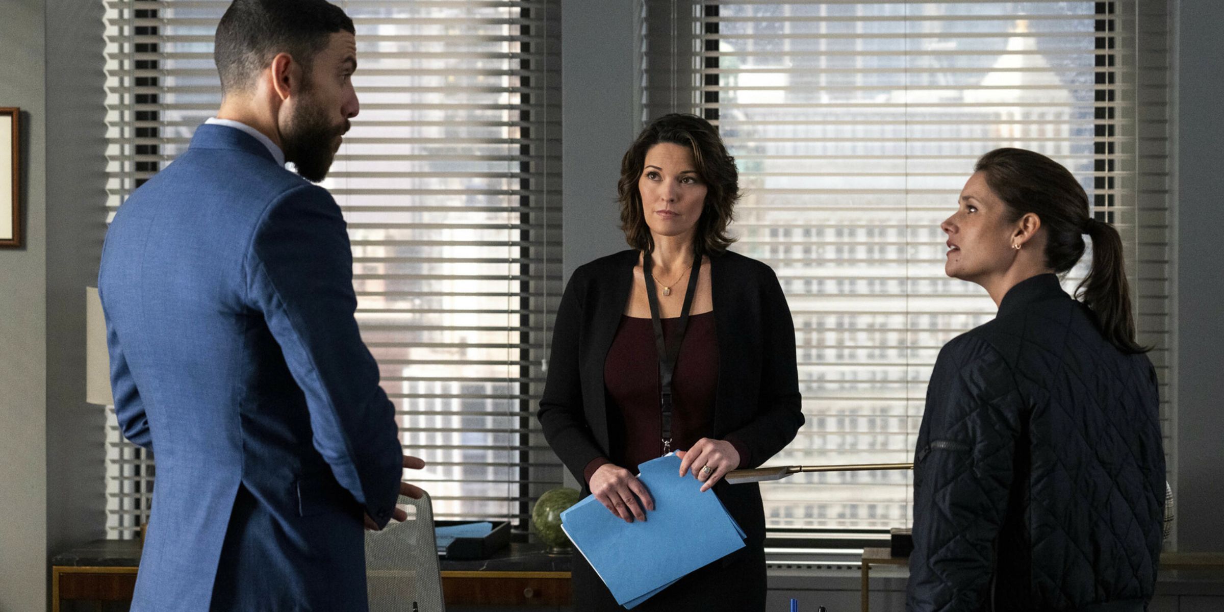 Zeeko Zaki and Missy Peregrym talking in front of Alana de la Garza in FBI