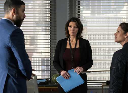 Zeeko Zaki and Missy Peregrym talking in front of Alana de la Garza in FBI