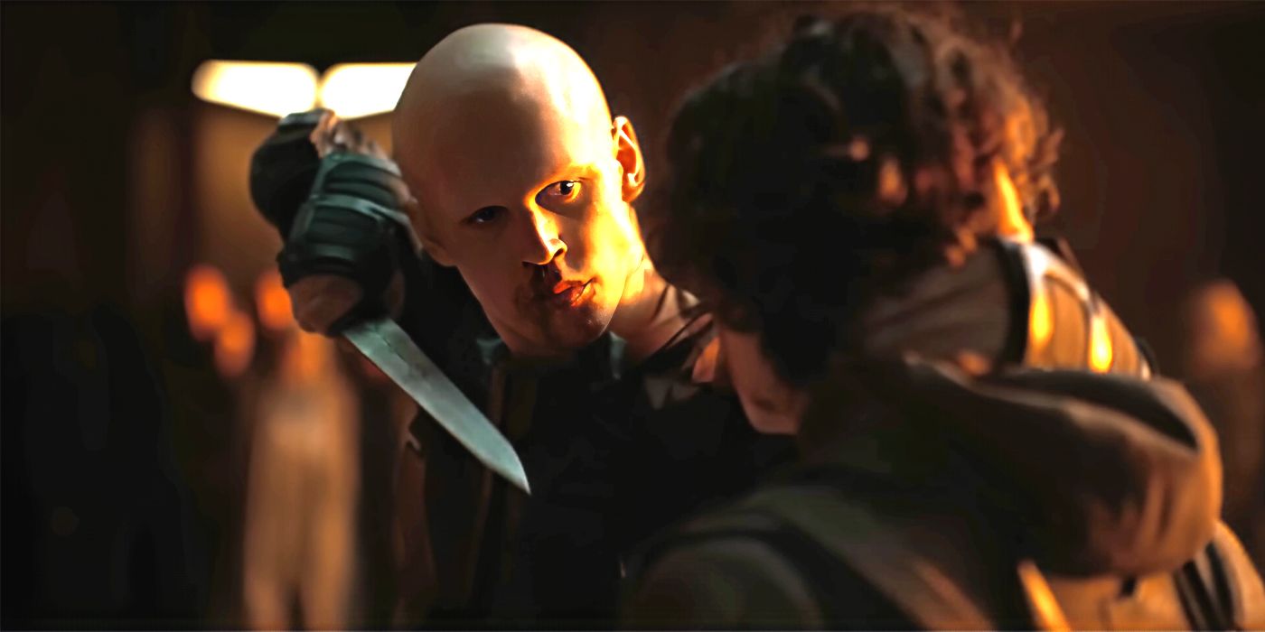 Austin Butler as Feyd-Rautha pointing a knife at Timothee Chalamet as Paul Atreides in Dune Part Two