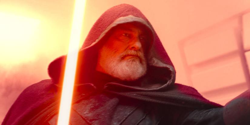 Baylan Skoll wearing a black hood and wielding his lightsaber in Ahsoka