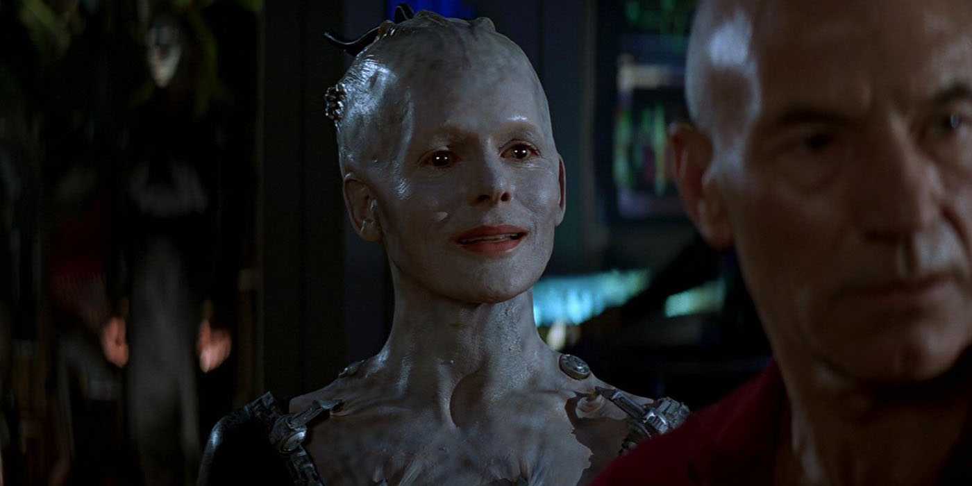 The Borg Queen, satisfied; Picard in blurry foreground