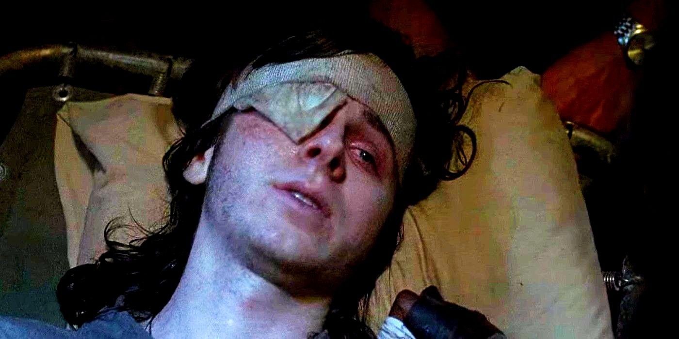 Chandler Riggs as Carl Grimes lying on a pillow after being bitten in The Walking Dead Season 9 Episode 8