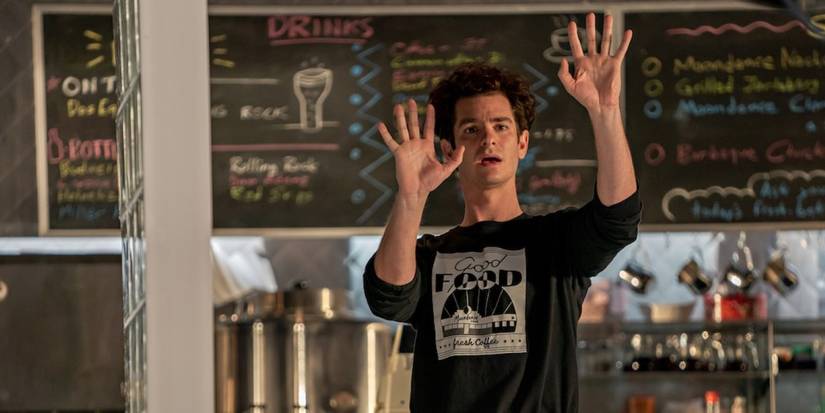 Jonathan Larson at work as a server with his arms out in Tick Tick Boom