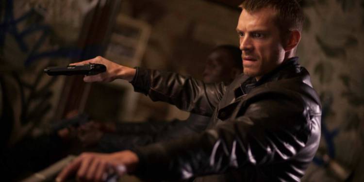 Joel Kinnaman holds two guns in Silent Night