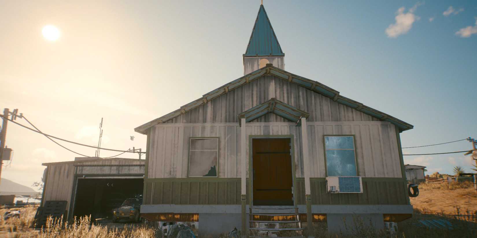A small, run-down church sits in the desert Badlands in a screenshot from Cyberpunk 2077.