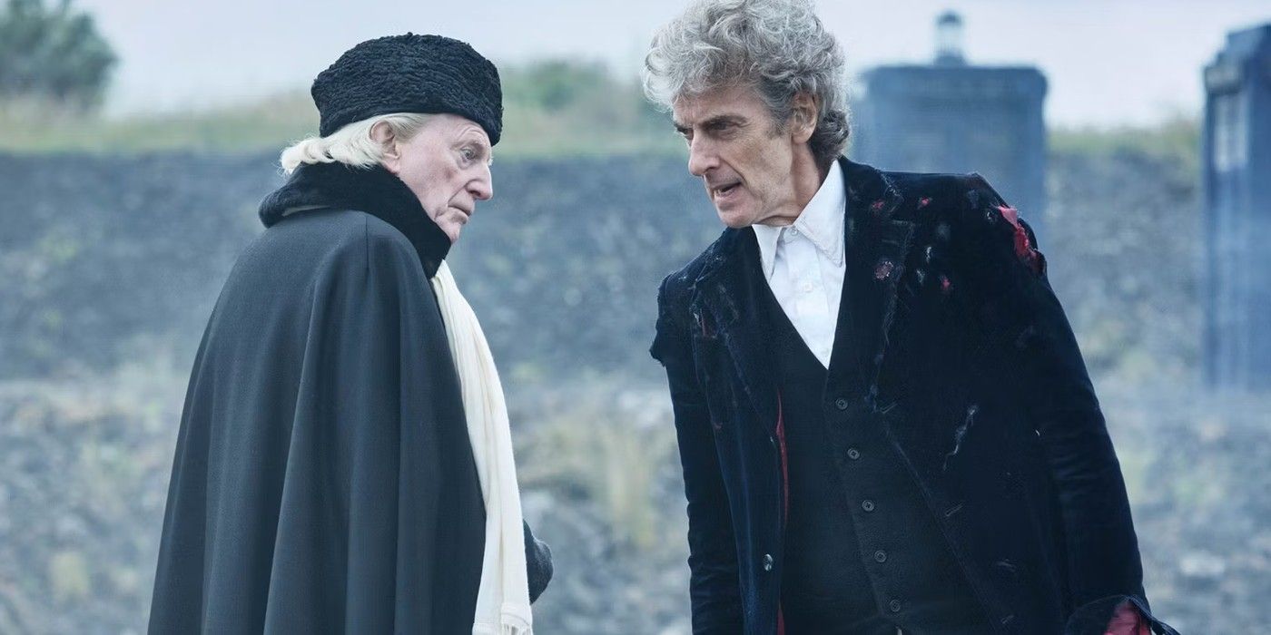 David Bradley as the First Doctor and Peter Capaldi as the Twelfth Doctor in a field with the TARDIS in the background in Doctor Who