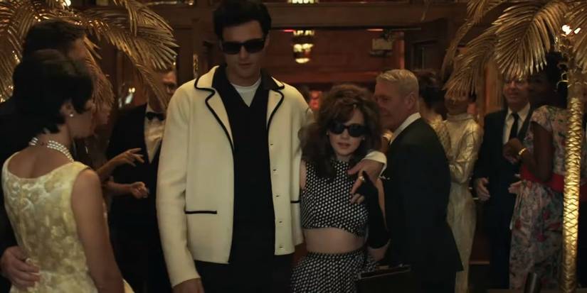 Elvis and Priscilla walk through a crowd in Priscilla