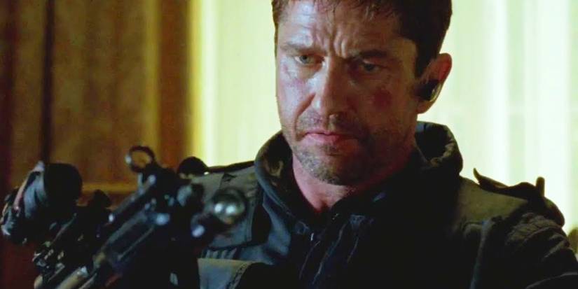 Gerard Butler loading a gun as Mike Banning in  Olympus Has Fallen.