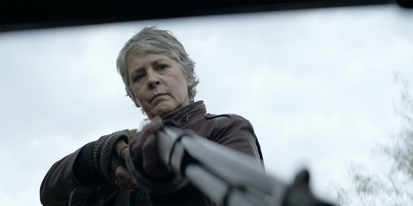 Melissa McBride as Carol pointing a gun in The Walking Dead: Daryl Dixon season 1 finale