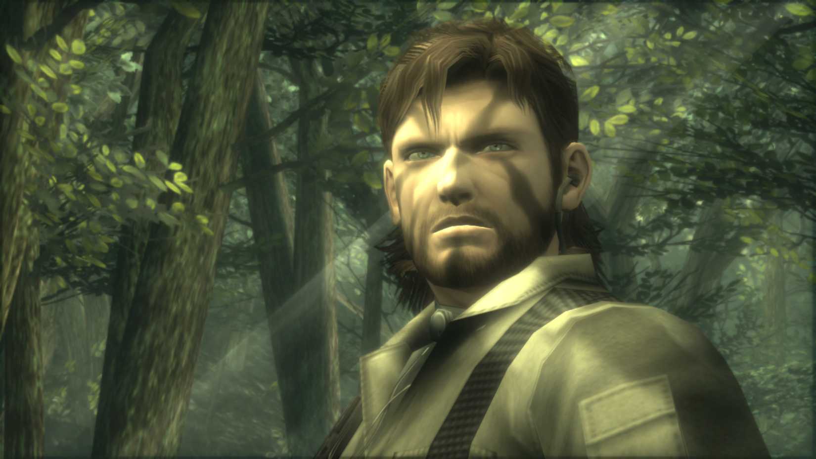 Screenshot from Metal Gear Solid 3 from the MGS:MCV1 show Naked Snake in the woods while beams of sunlight shine through the trees.