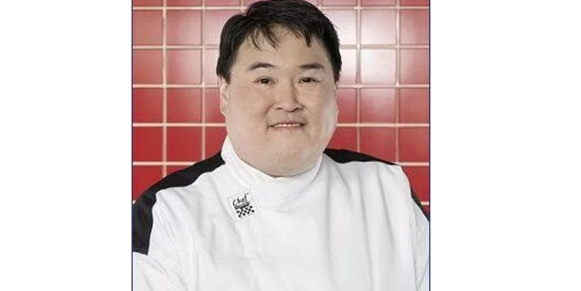Aaron Song from Hell's Kitchen season 3 smiling in front of red background
