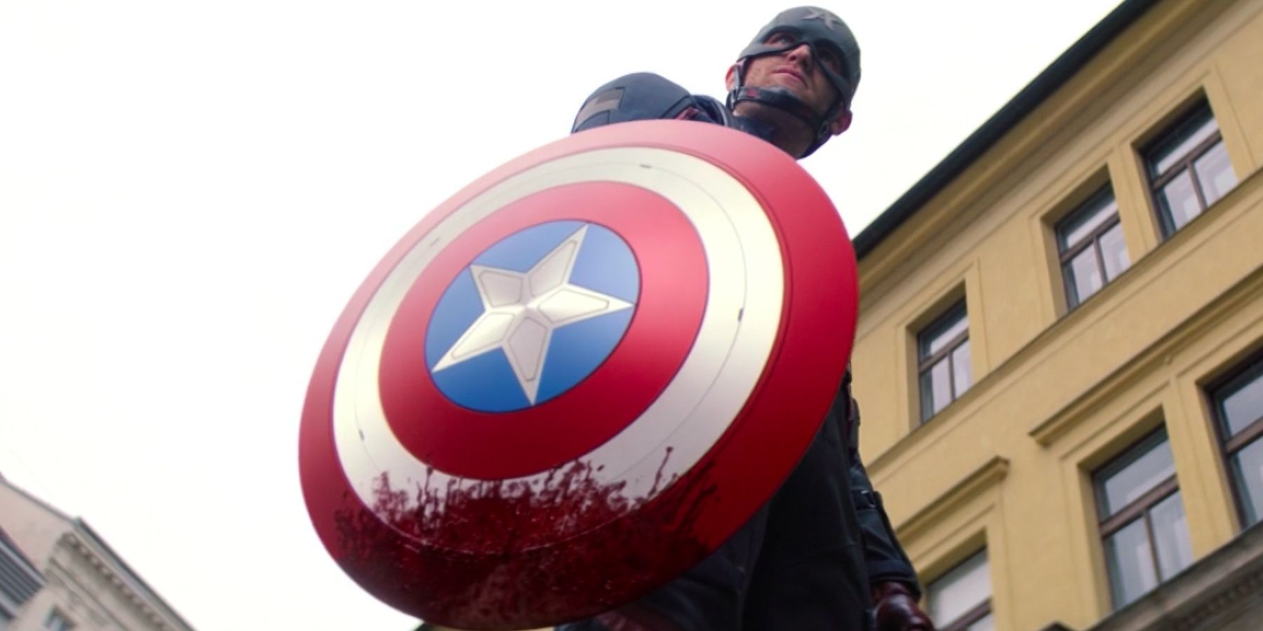 us agent stands with a bloodied shield in Falcon and the Winter Soldier