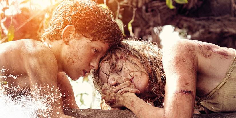 Tom Holland And Naomi Watts holding hands and looking disheveled In The Impossible