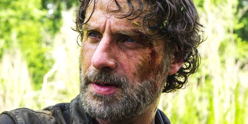 Rick Grimes (Andrew Lincoln) with a beard and disheveled hair, frowning, on The Walking Dead.