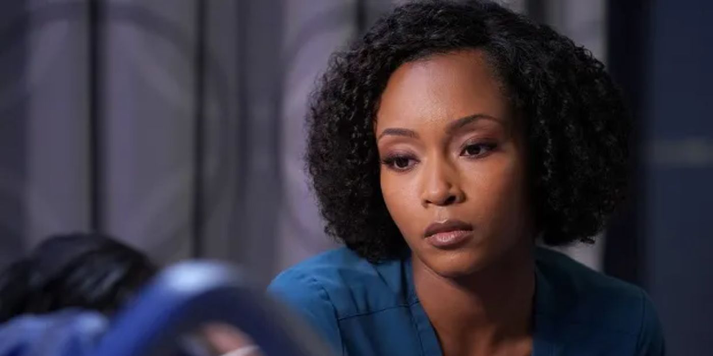 April Sexton looking at a patient in Chicago Med