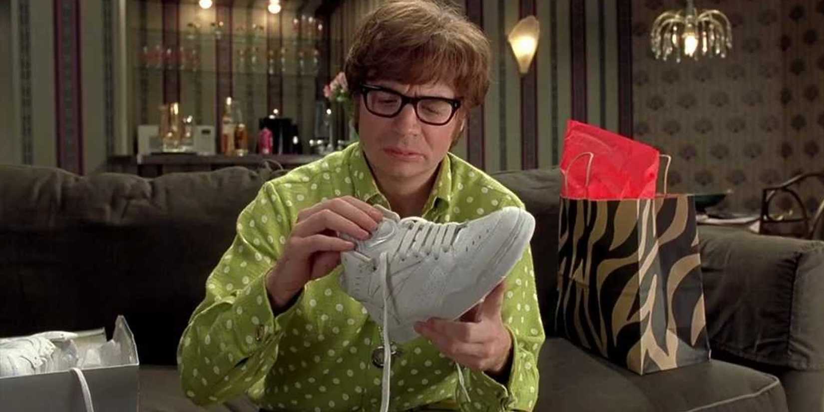 Austin Powers looking confused at a Reebok shoe