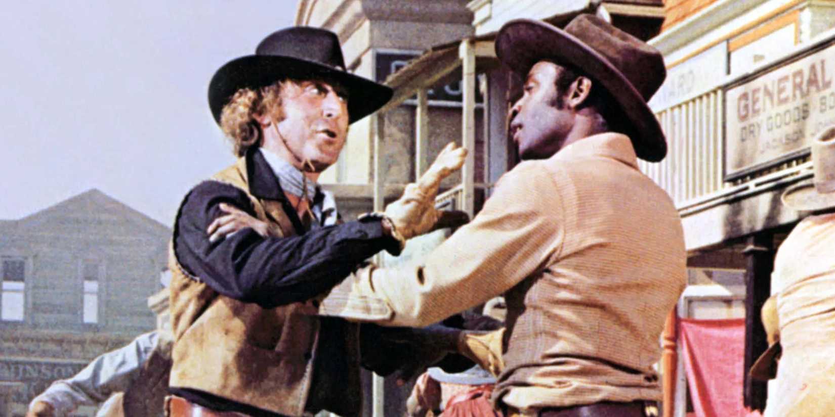 Jim (Gene Wilder) and Bart (Cleavon Little) holding each other in a fight in Blazing Saddles