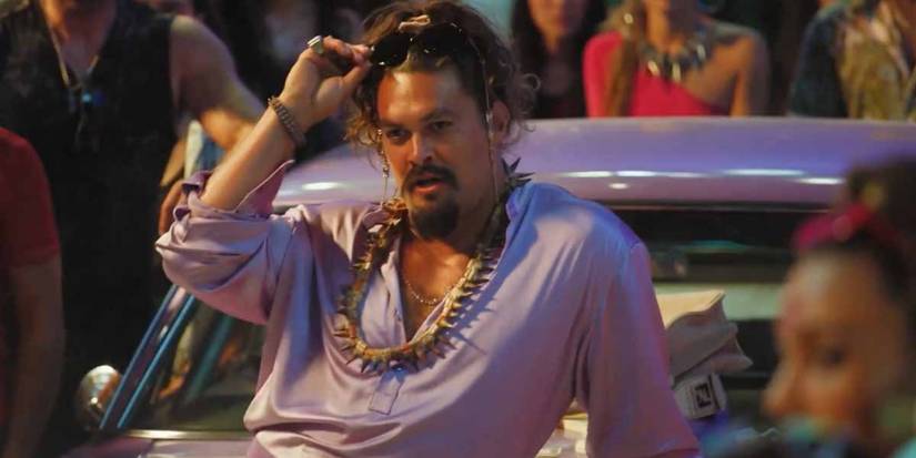 Dante (Jason Momoa) provocatively leaning on his car before as street race in Fast X.