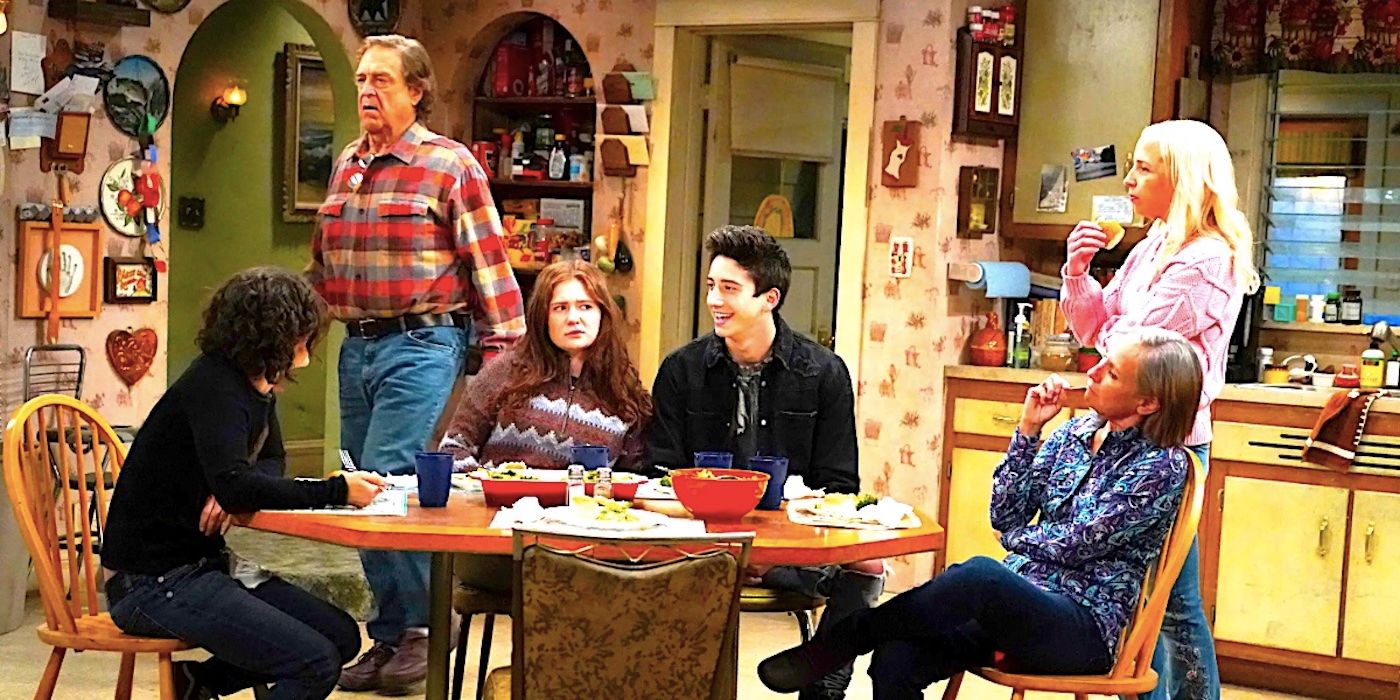 Darlene, Dan, Harris, Becky, Jackie and a guest sit around the kitchen table in The Conners