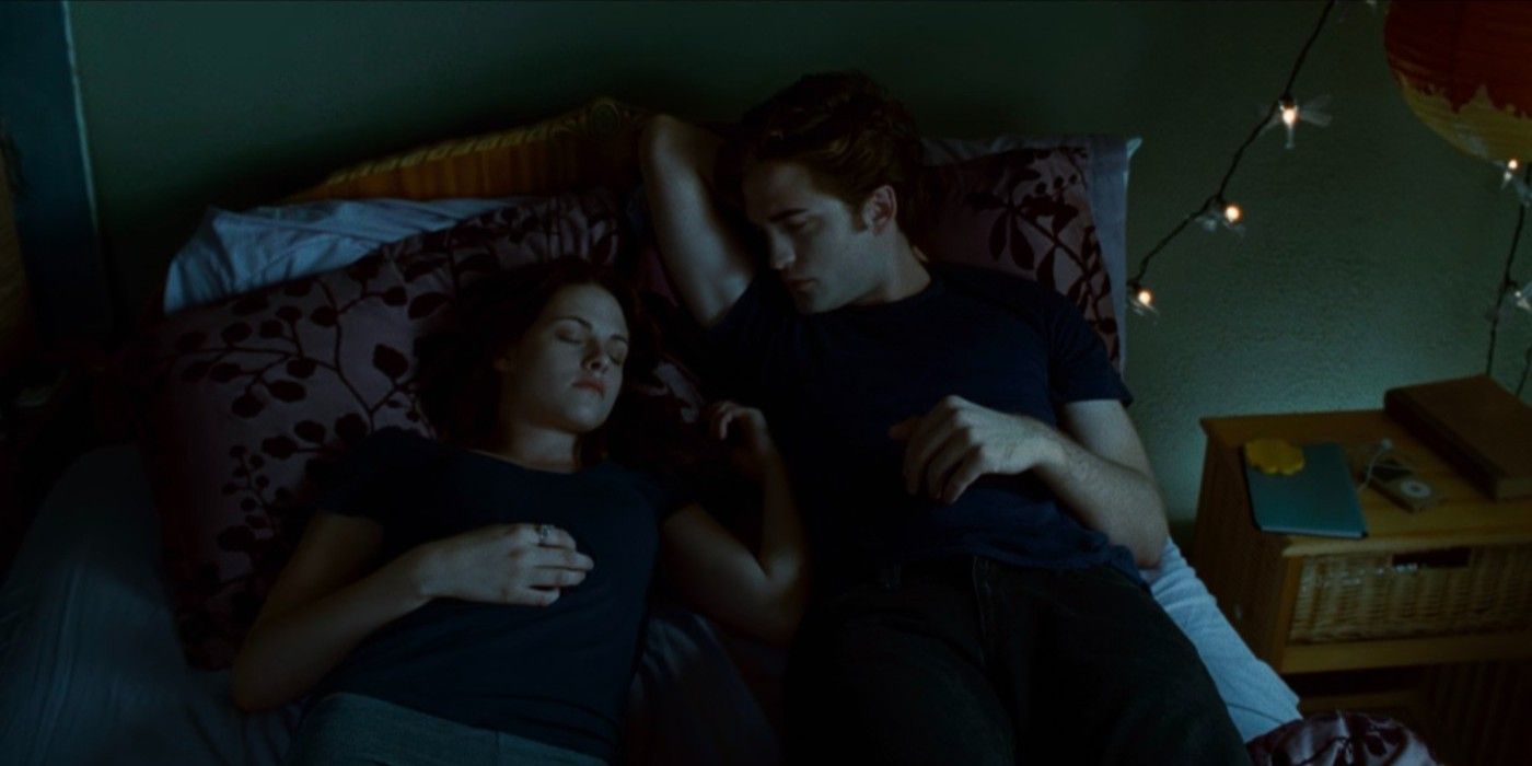 Robert Pattinson as Edward Cullen watching Kristen Stewart as Bella Swan sleep in Twilight