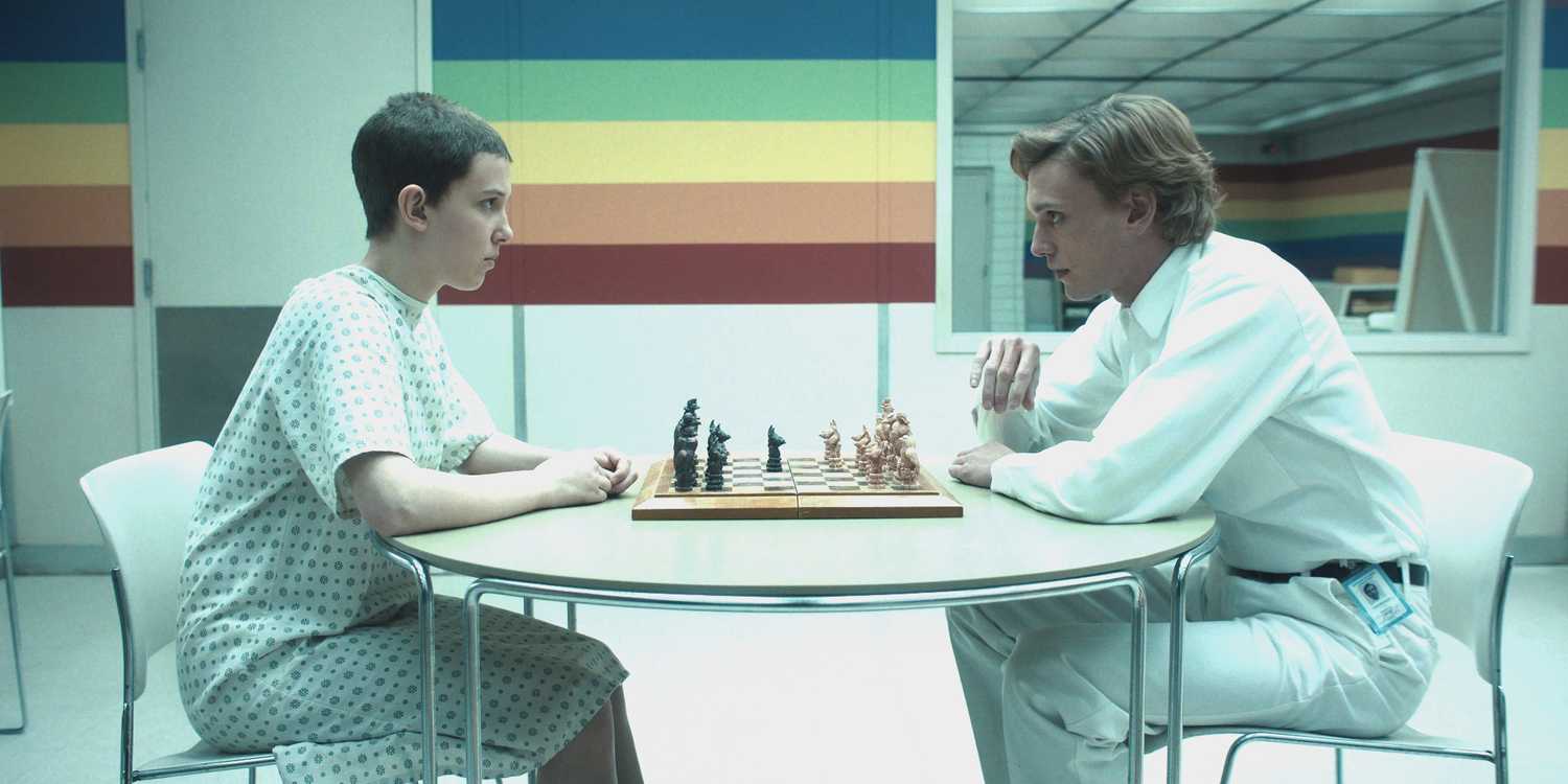 Millie Bobby Brown as Eleven and Jamie Campbell Bower as Creel playing a game of chess in Stranger Things season 4.