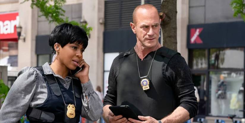 Elliot and Ayanna talking on the phone and looking at something in Law and Order Organized Crime