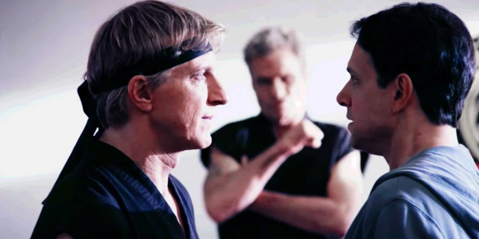 Johnny and Daniel stare each other down as Kreese looks on in a scene from Cobra Kai