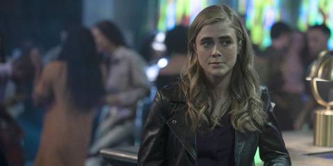 Michaela leaning on a bar and wearing a leather jacket in Manifest