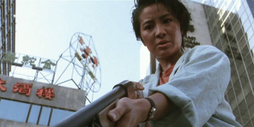 Michelle Yeoh holds a sH๏τgun pointed downward in Yes Madam!