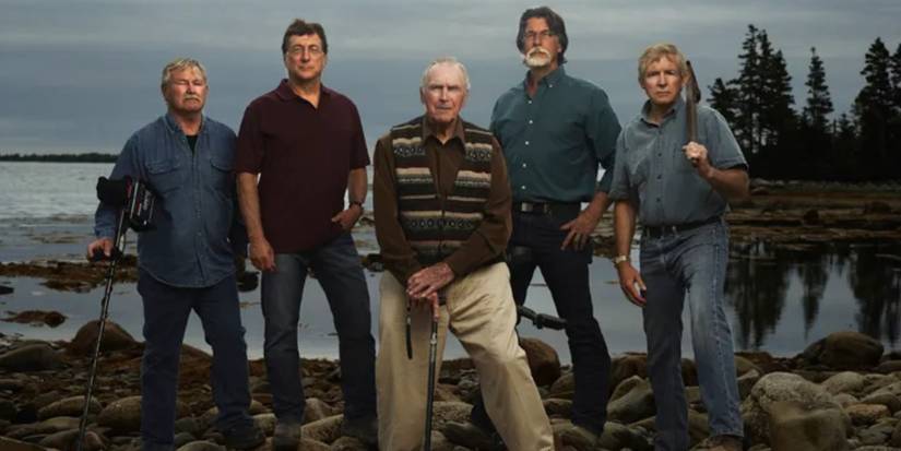 The cast of The Curse of Oak Island by a lake